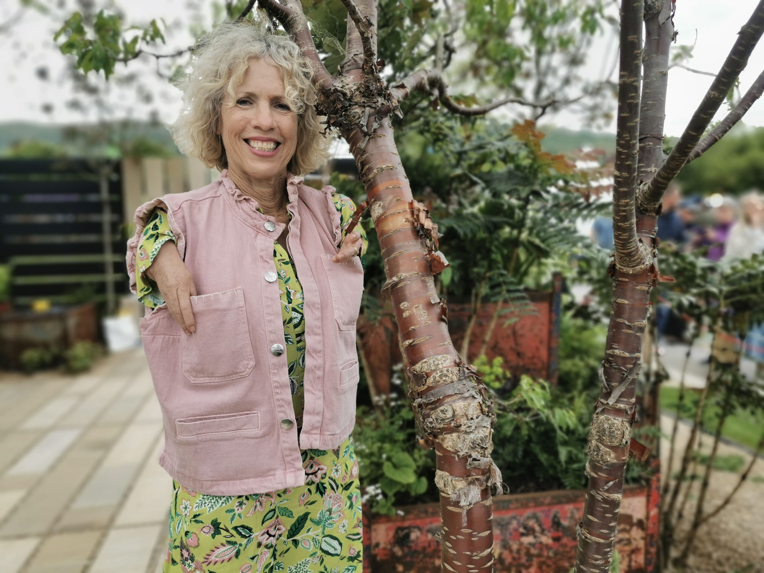 Sue Kent standing next to a plant