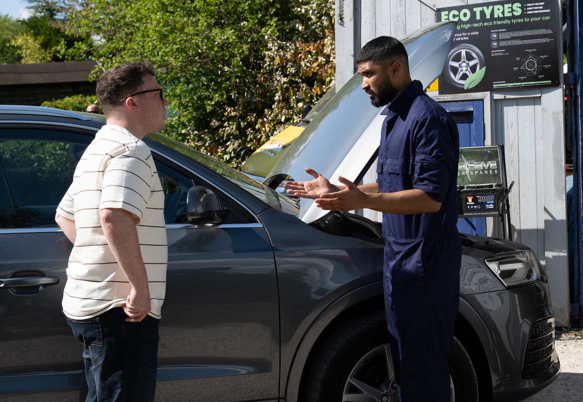 Vinny and Kammy talking to each other at the garage