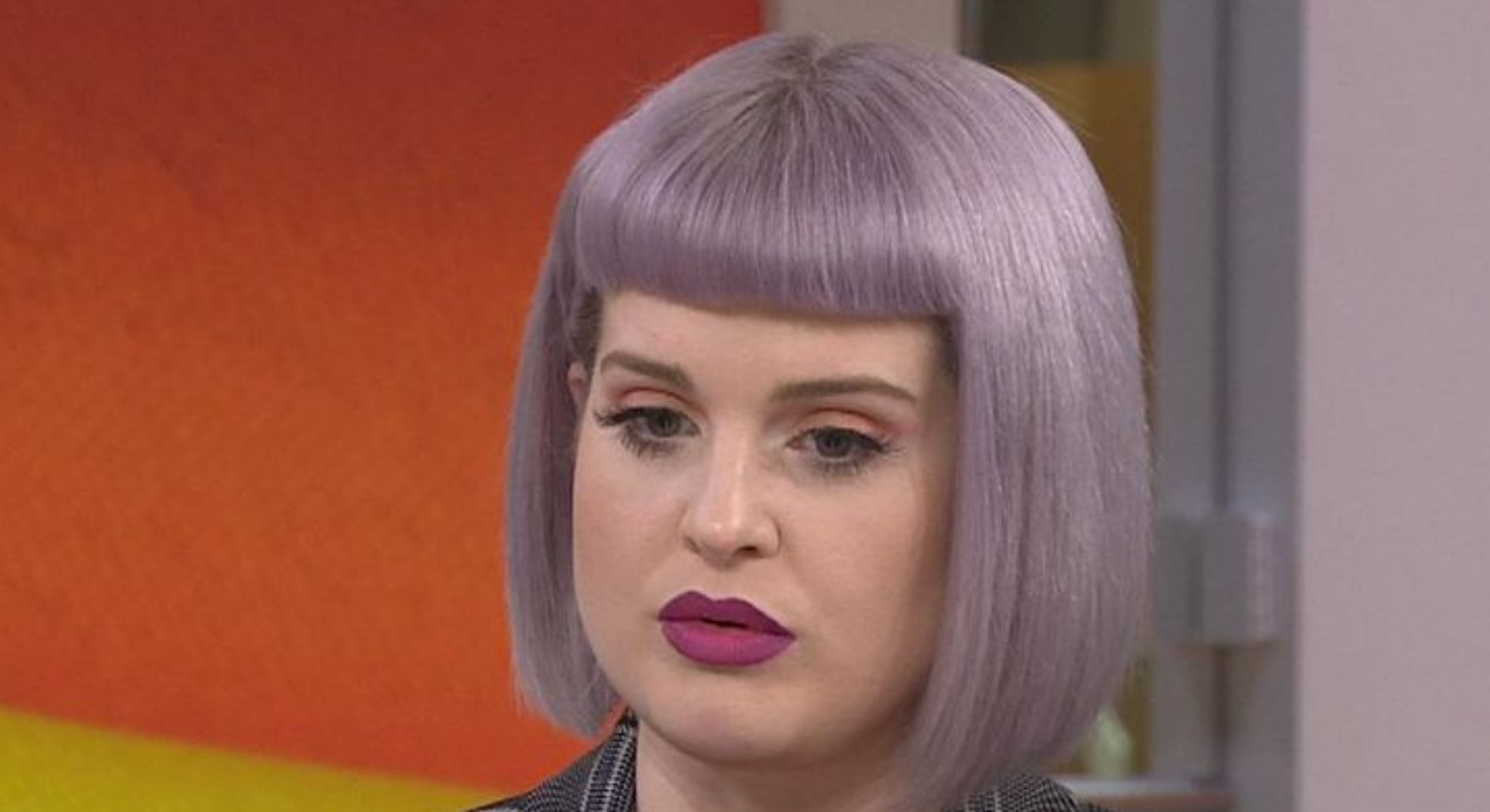 Kelly Osbourne looking down