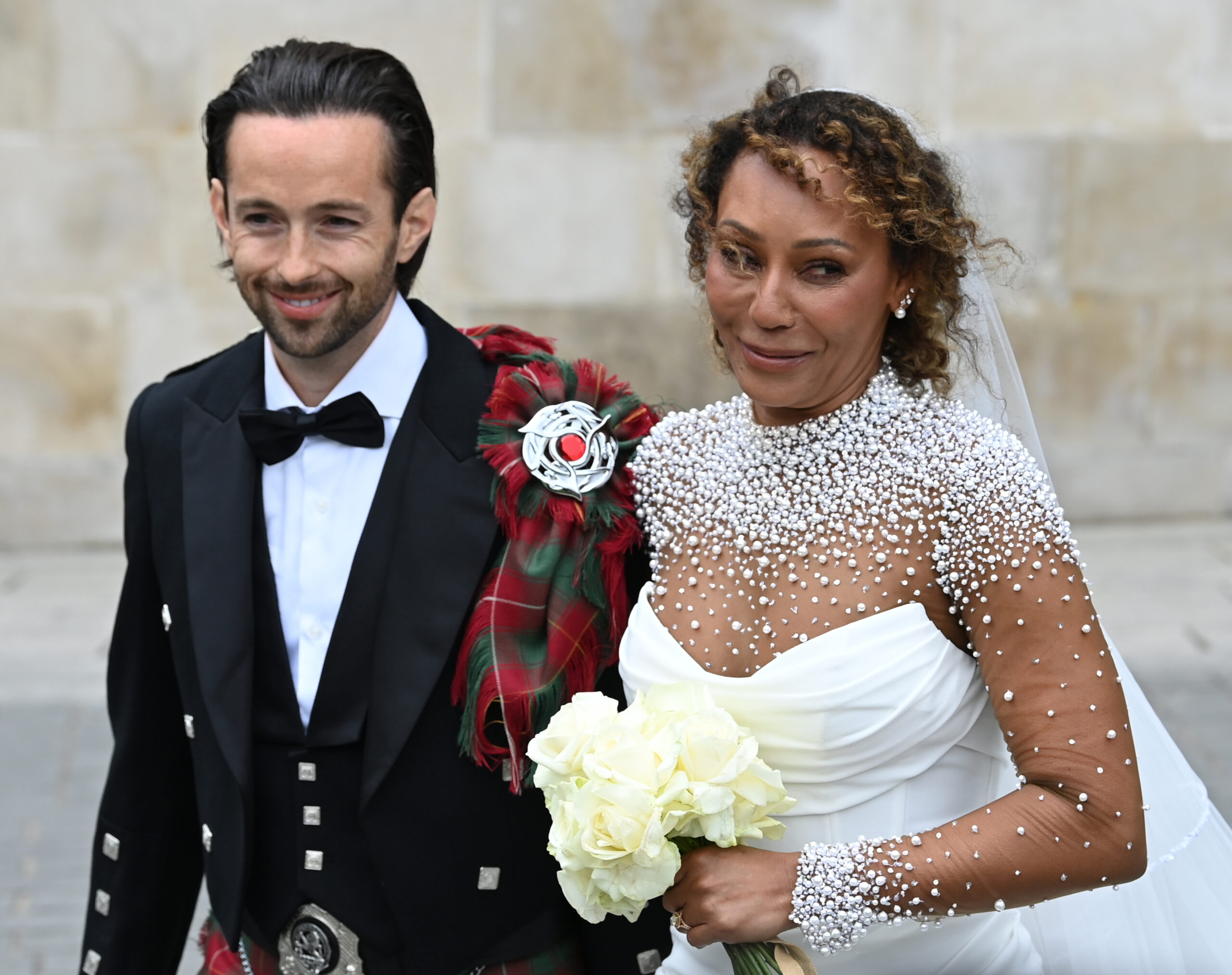 Mel and husband smiling at wedding