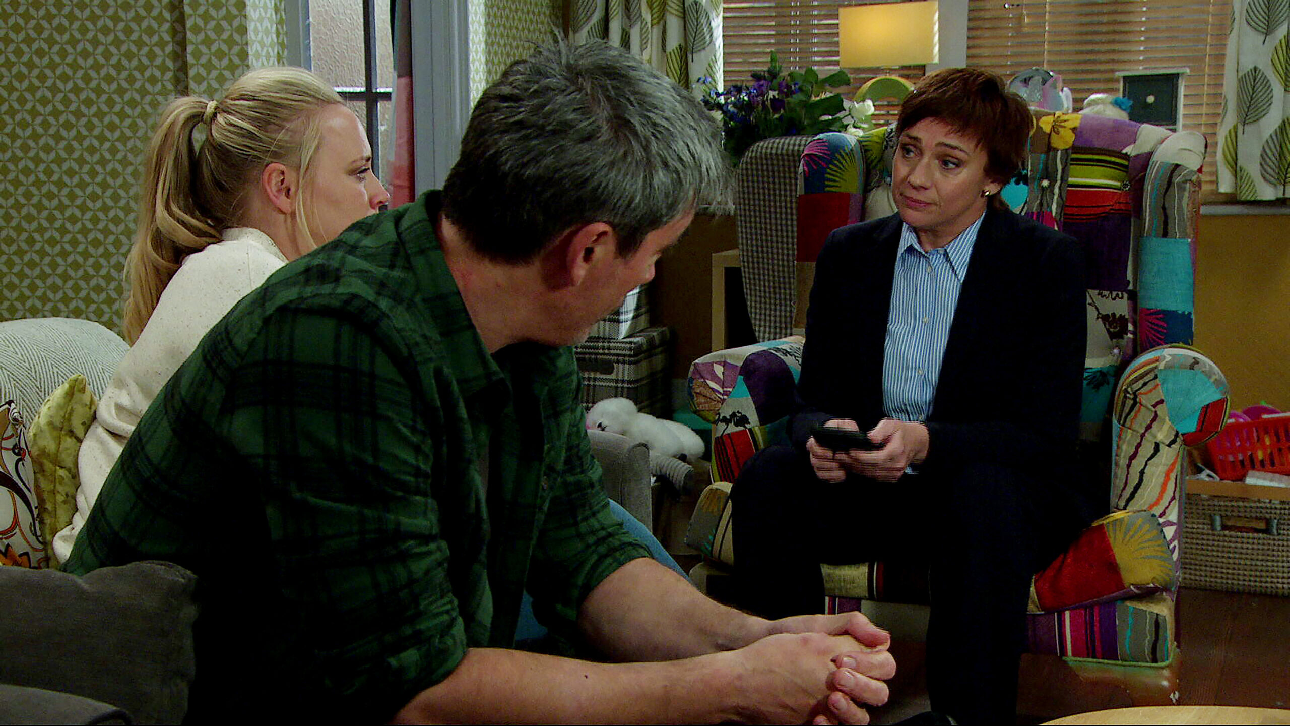 Cain and Tracy talking to DS Walsh in Emmerdale