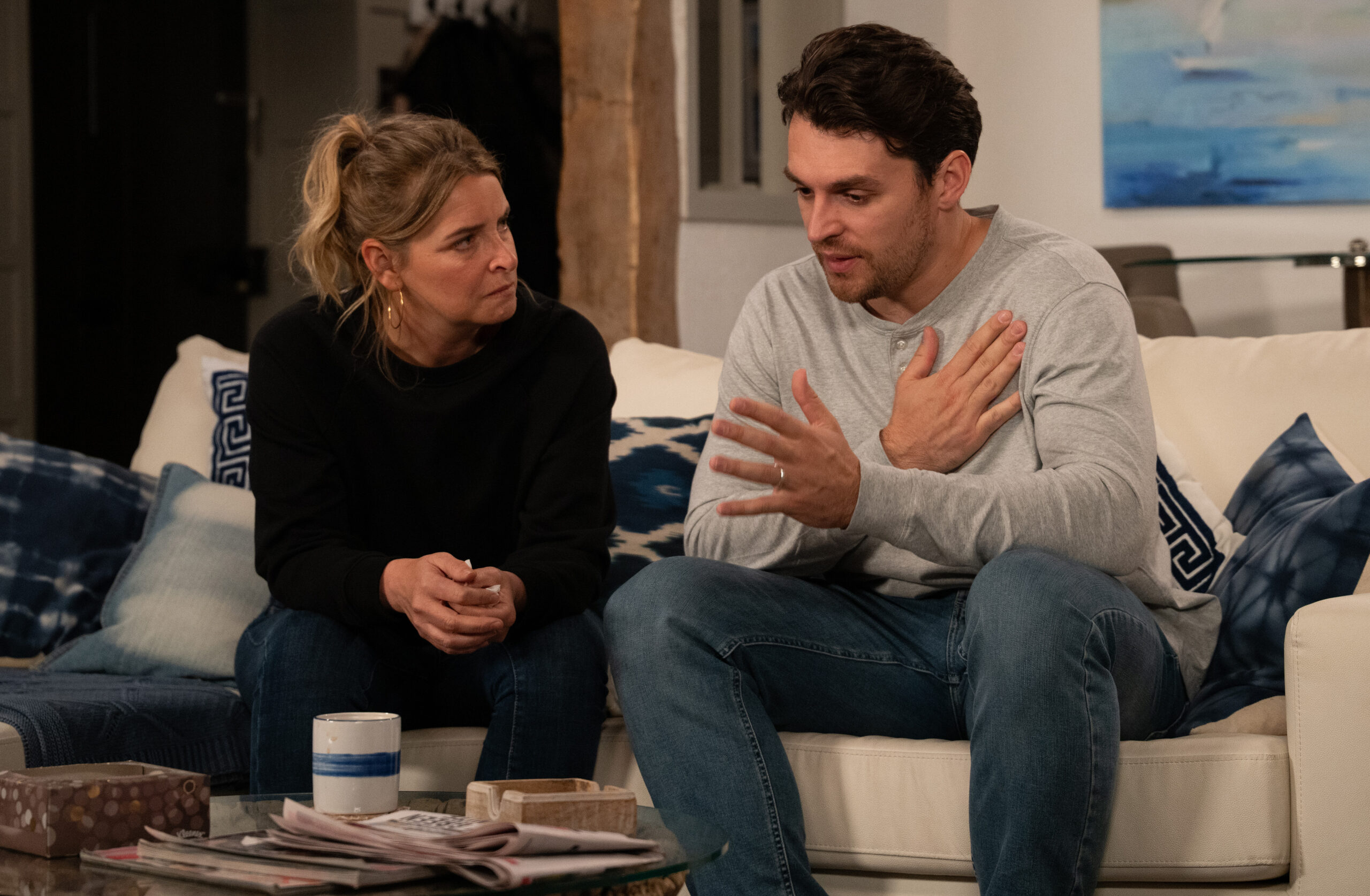 Charity and Mack talking on the sofa in Emmerdale