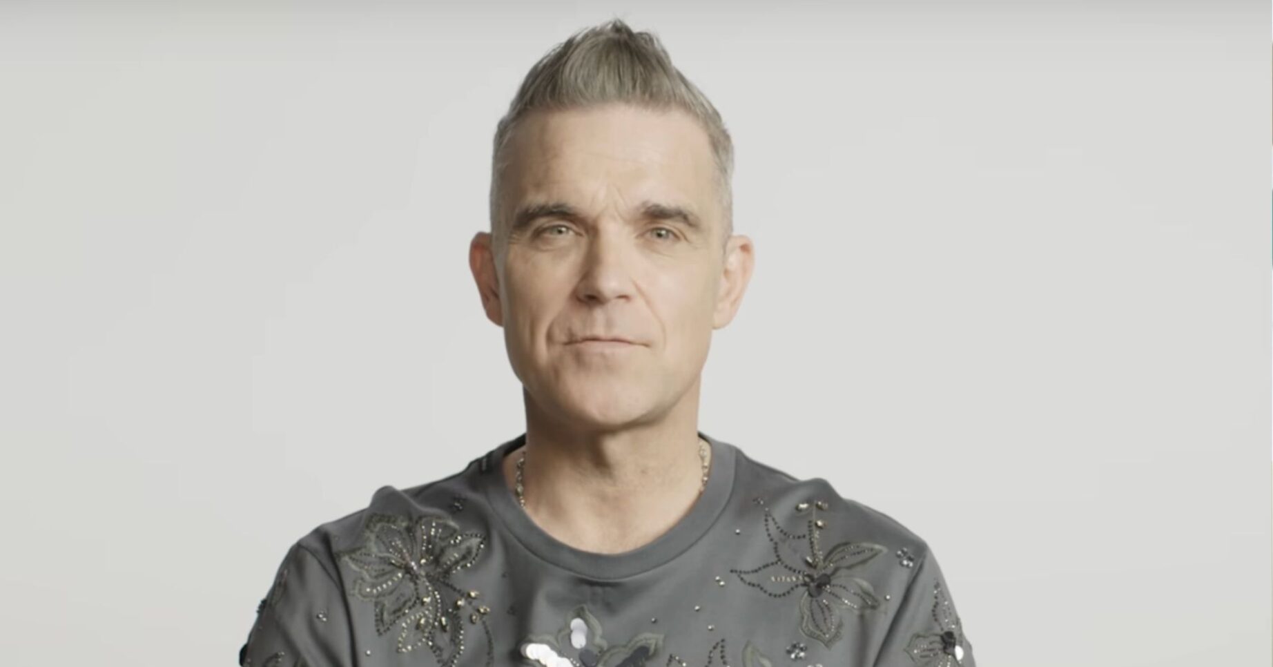 Robbie Williams speaking to camera