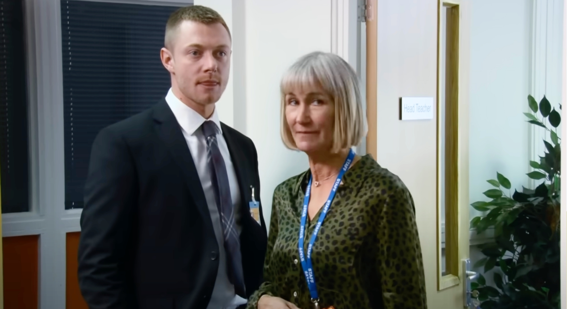 Coronation Street's Daniel and Mrs Crawshaw standing together at the school