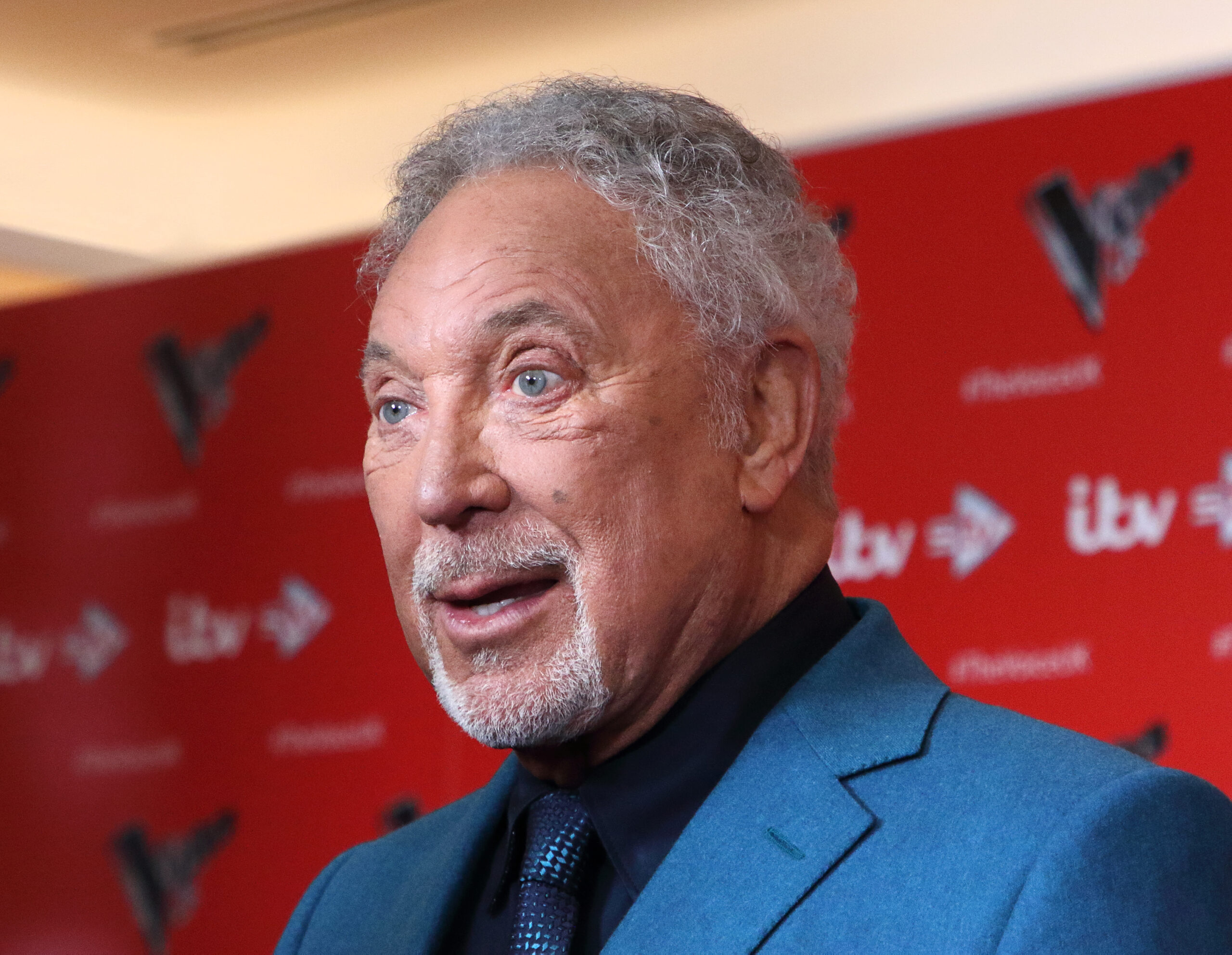 Sir Tom Jones speaking at a press event 