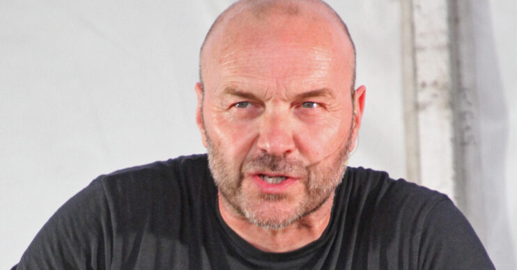 Simon Rimmer in a black T-shirt doing a cooking demonstration