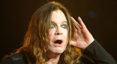 Ozzy Osbourne cups his ear