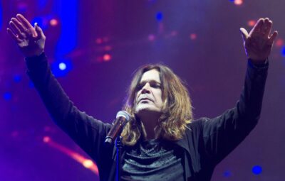 Ozzy Osbourne playing to a concert crowd