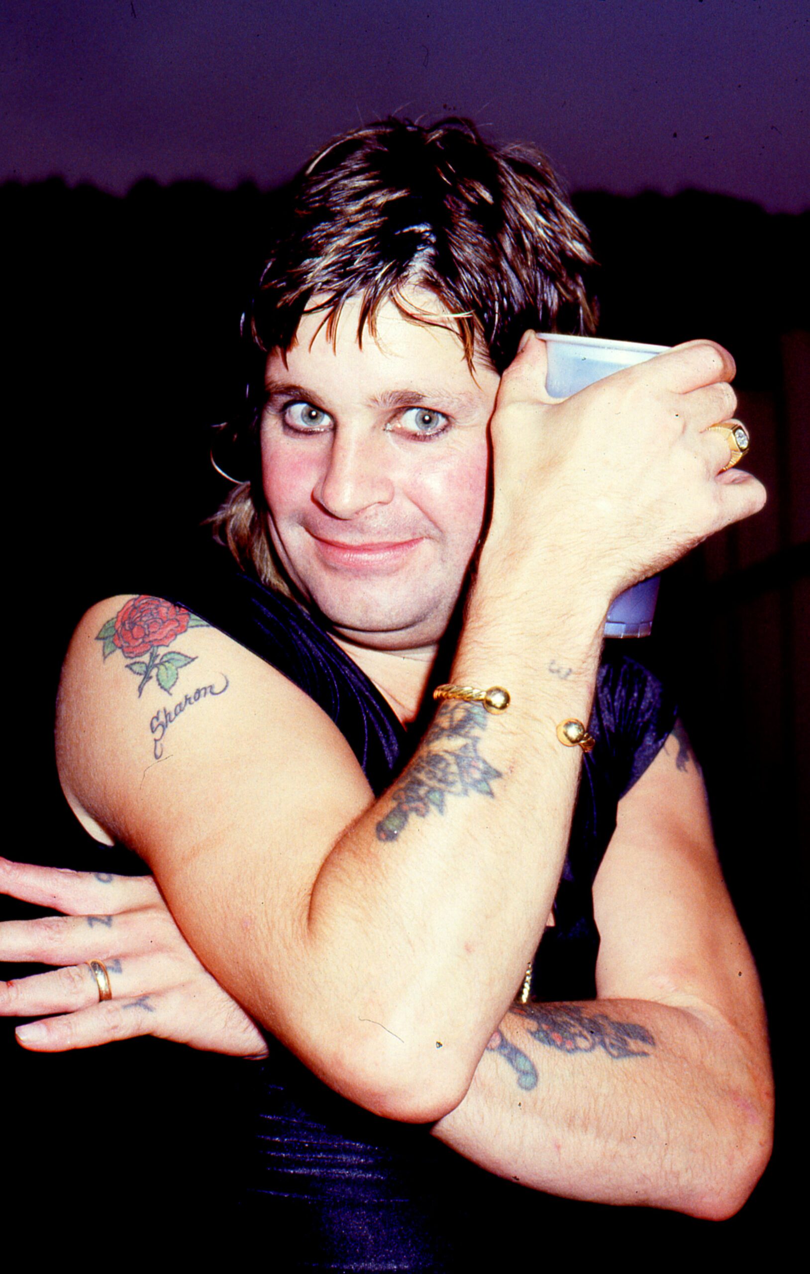 Ozzy Osbourne in his early days holding a drink