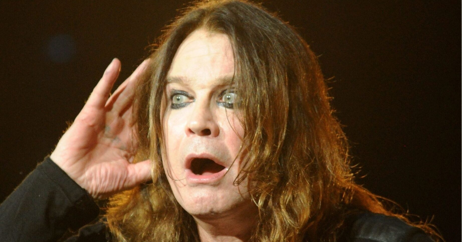 Ozzy Osbourne cups his ear