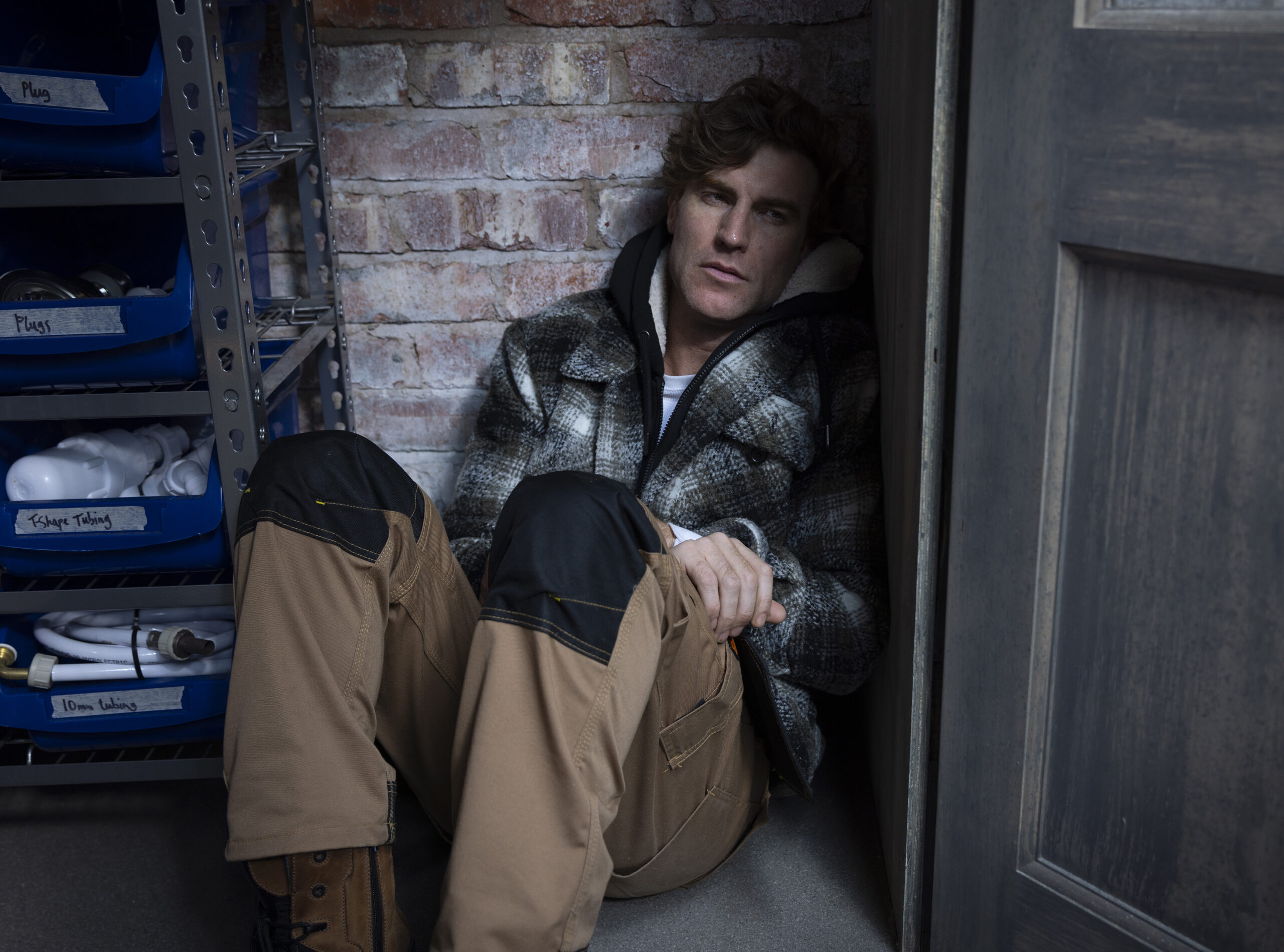 Upset Theo hiding at the builder's yard in Coronation Street