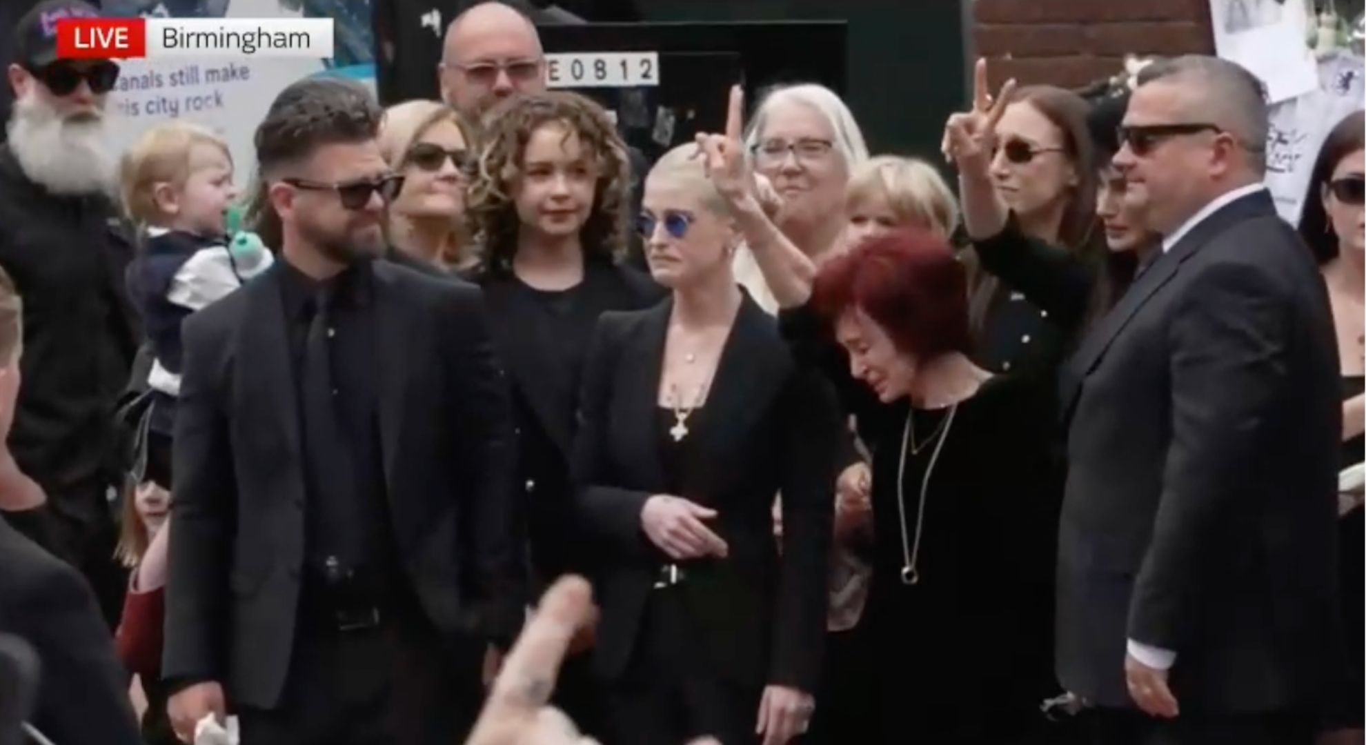 The Osbourne family crying at Ozzy's funeral
