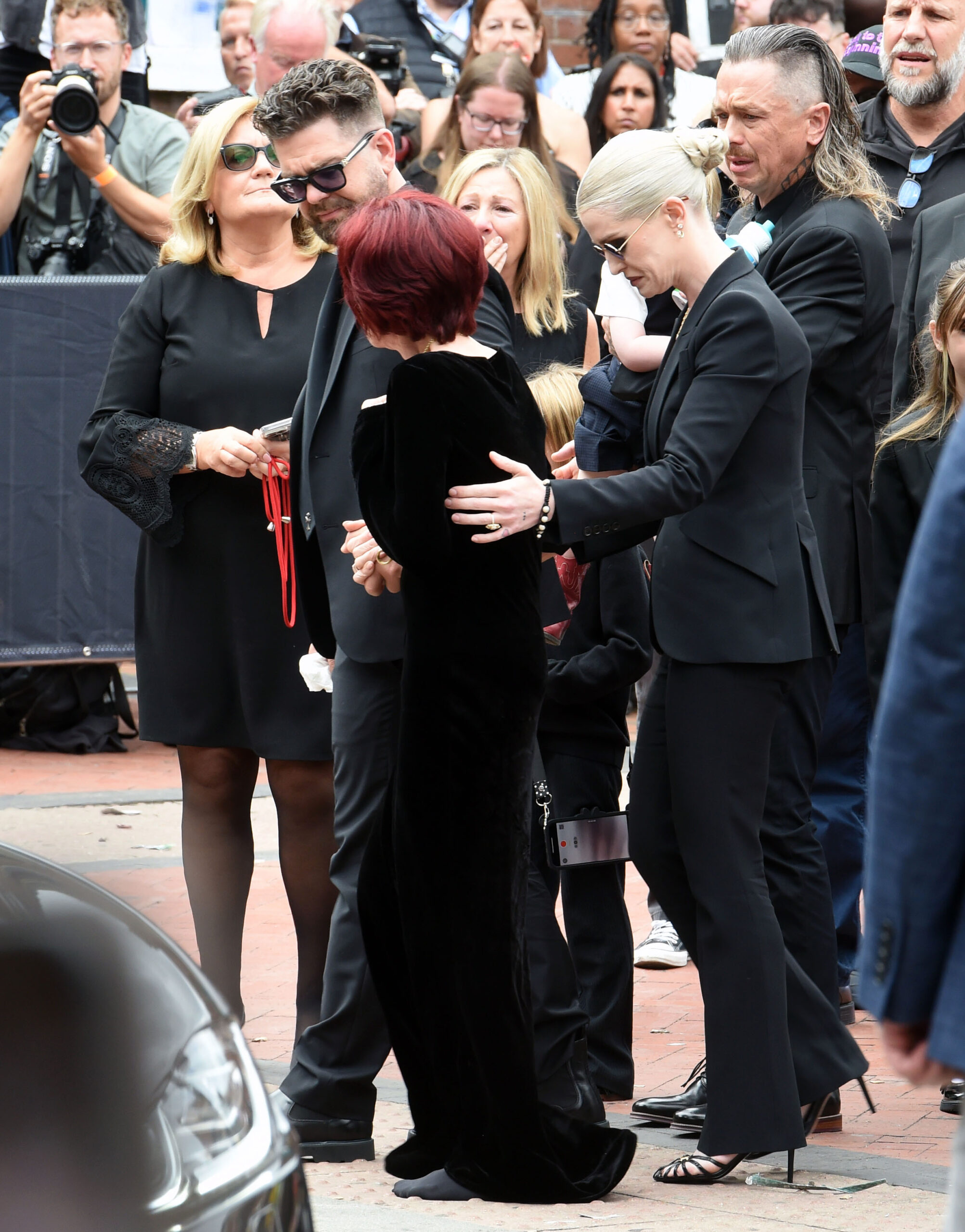 Jack and Kelly assisting Sharon Osbourne at Ozzy's funeral