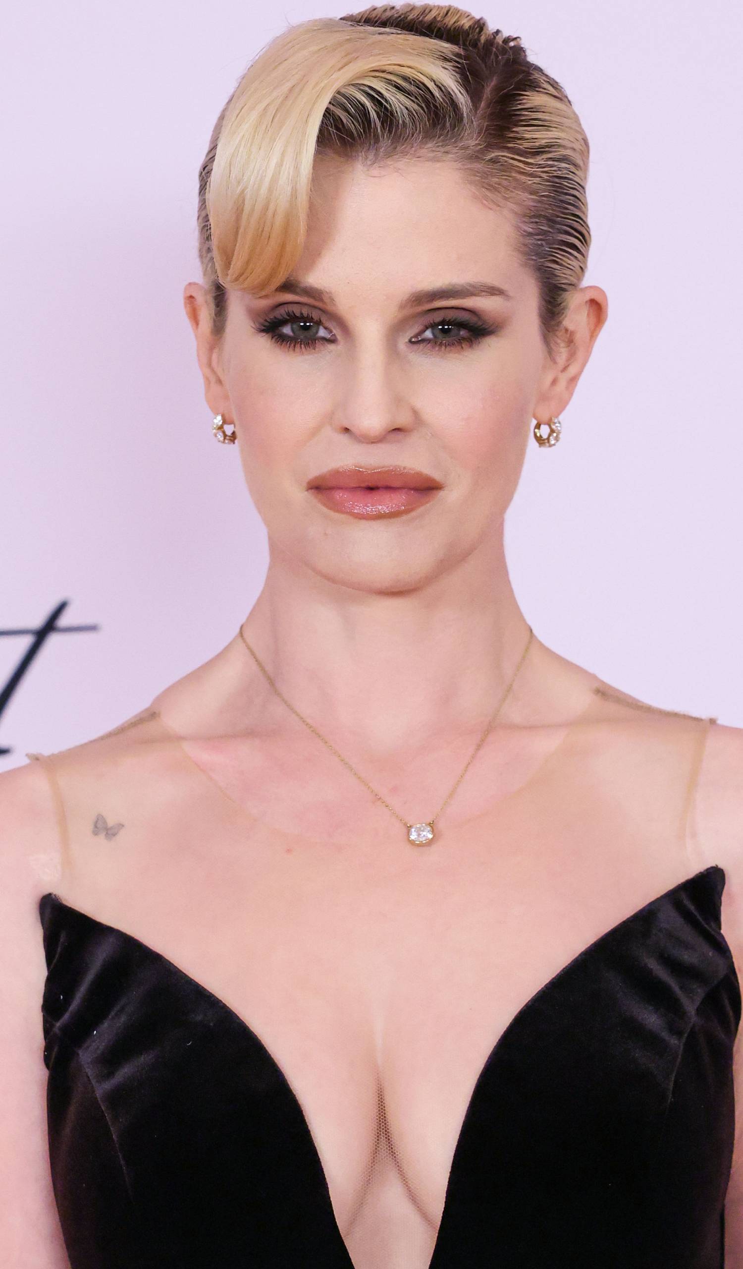 Kelly Osbourne looks into the camera