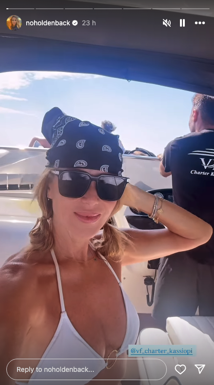 Amanda Holden wearing a bandana on a boat