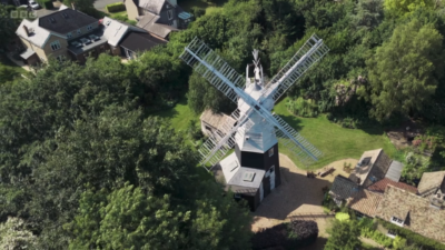 A windmill in the middle of a garden