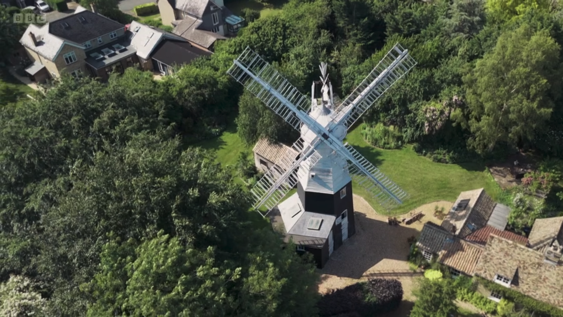 A windmill in the middle of a garden