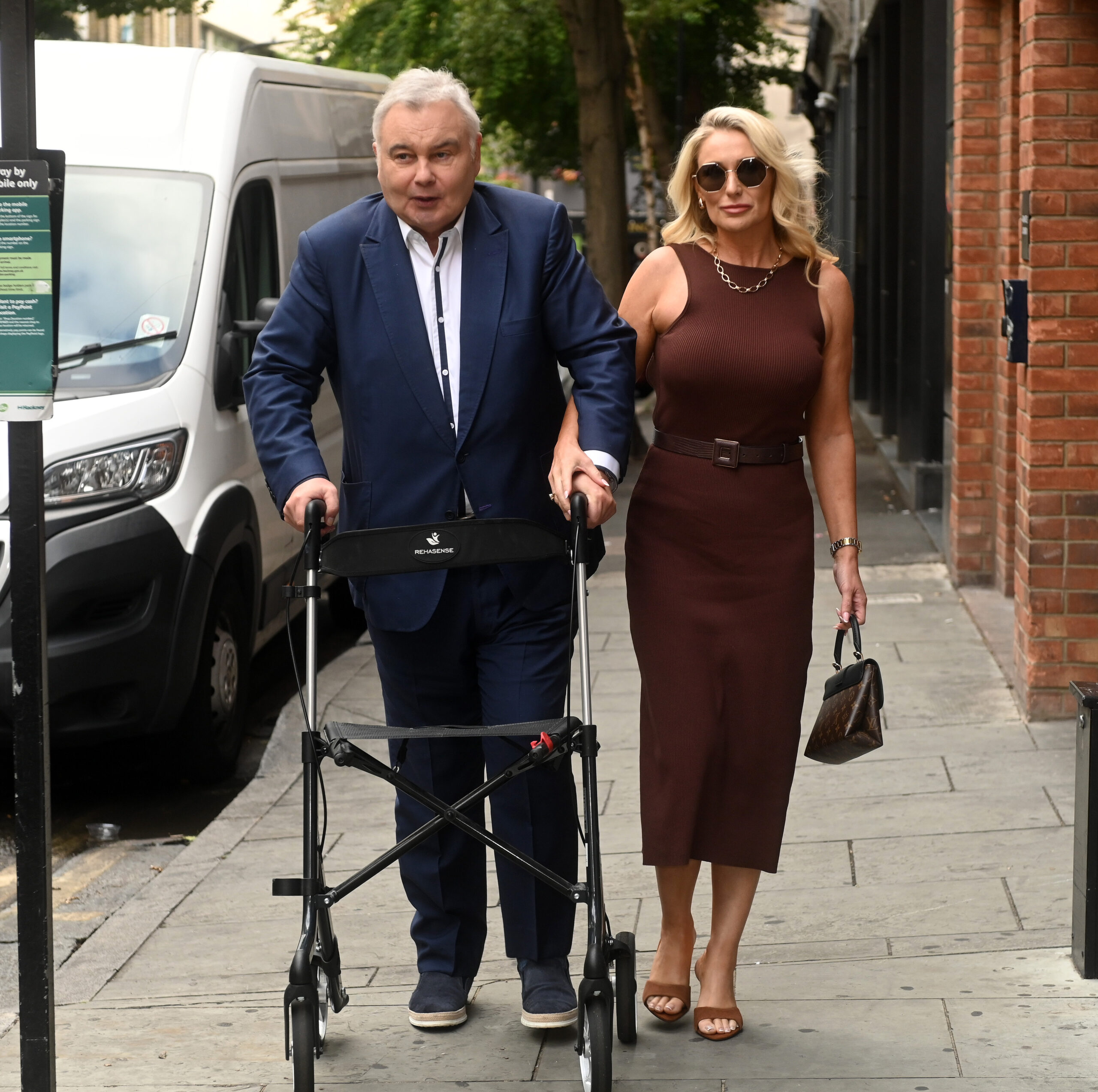 Eamonn Holmes using a walker with his girlfriend Katie Alexander