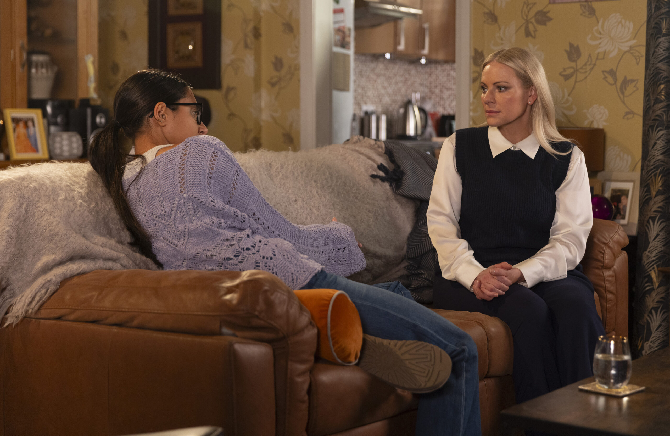 Asha talking to Lisa on the sofa