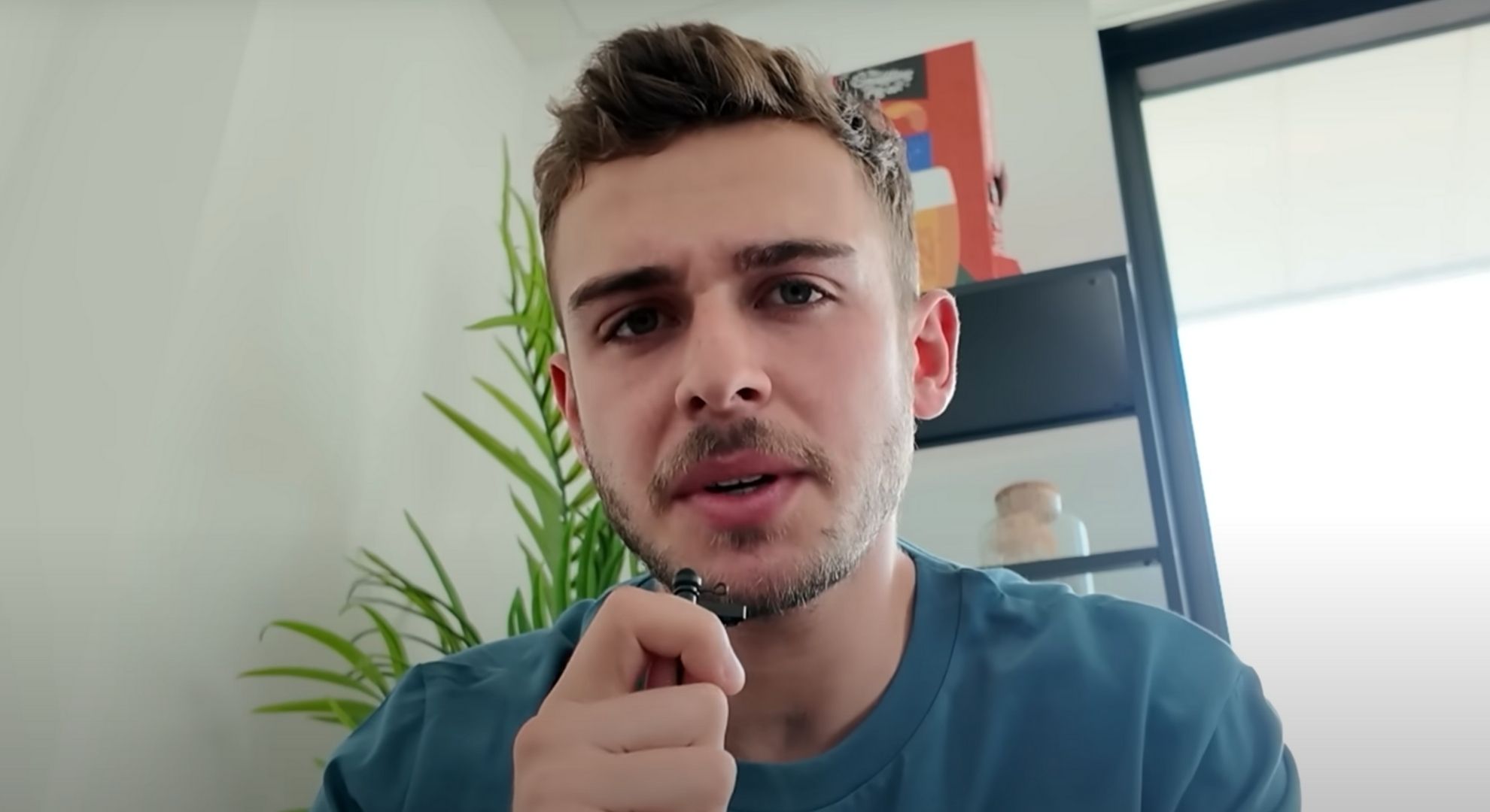 George Clark talking to the camera in a blue shirt.