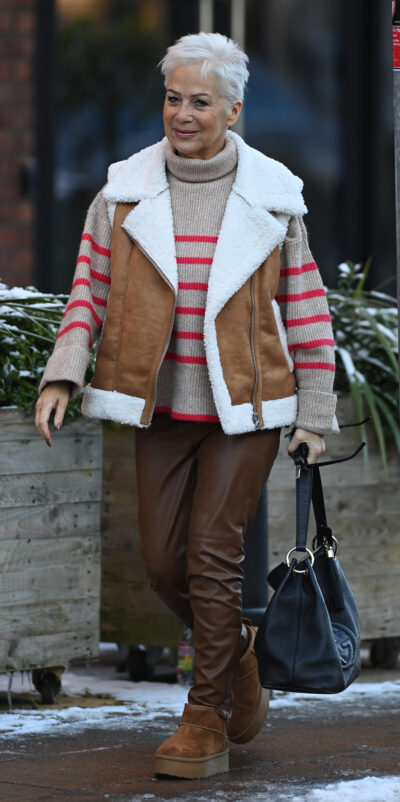 Denise Welch walking in Wilmslow wearing a brown jacket.