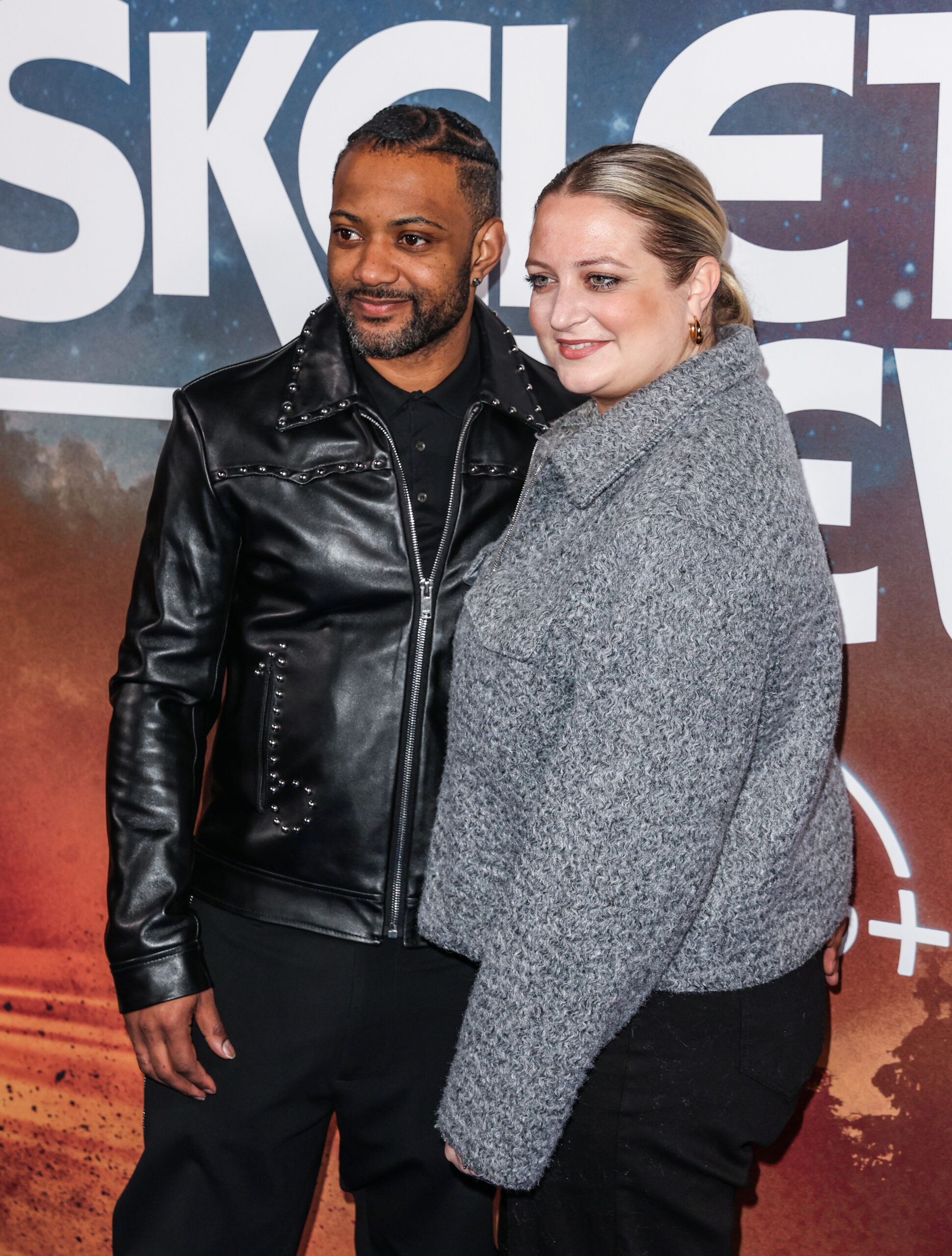 JB Gill and wife Chloe smiling on the red carpet