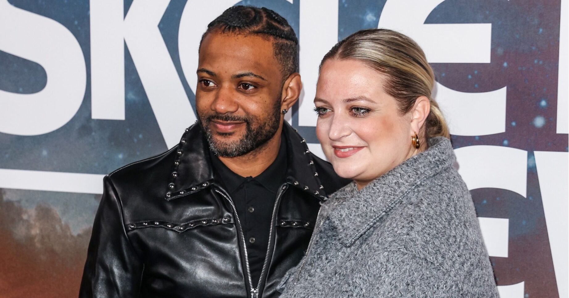 JB Gill and wife Chloe smiling on the red carpet