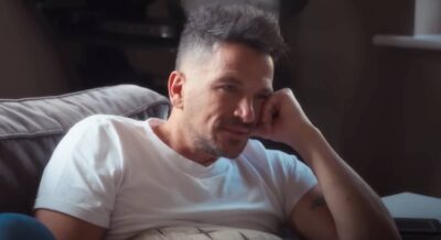 Peter Andre rests his face on his hand