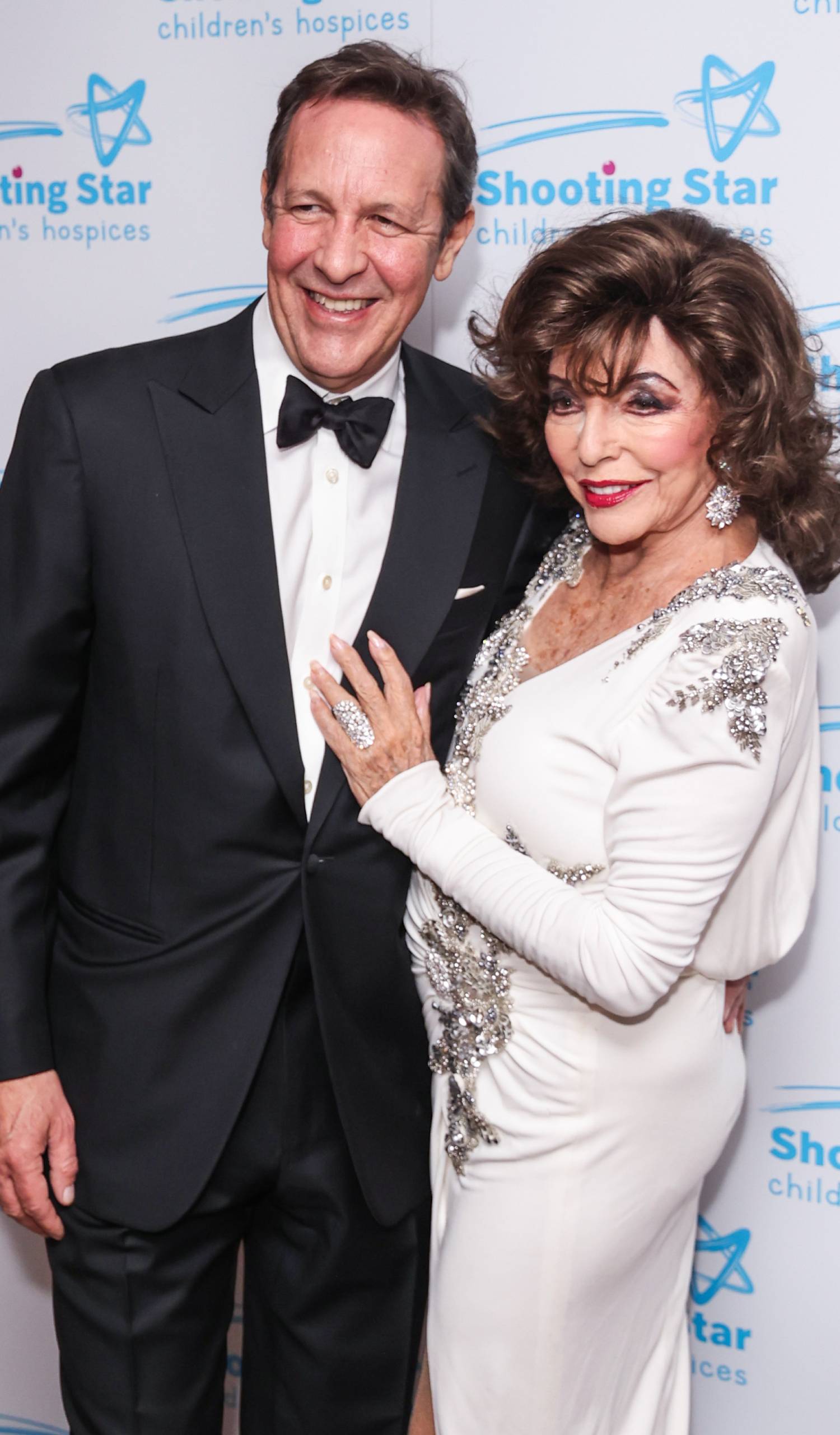 Joan Collins poses with her husband Percy