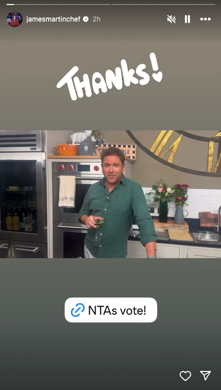 James Martin holding a glass of wine