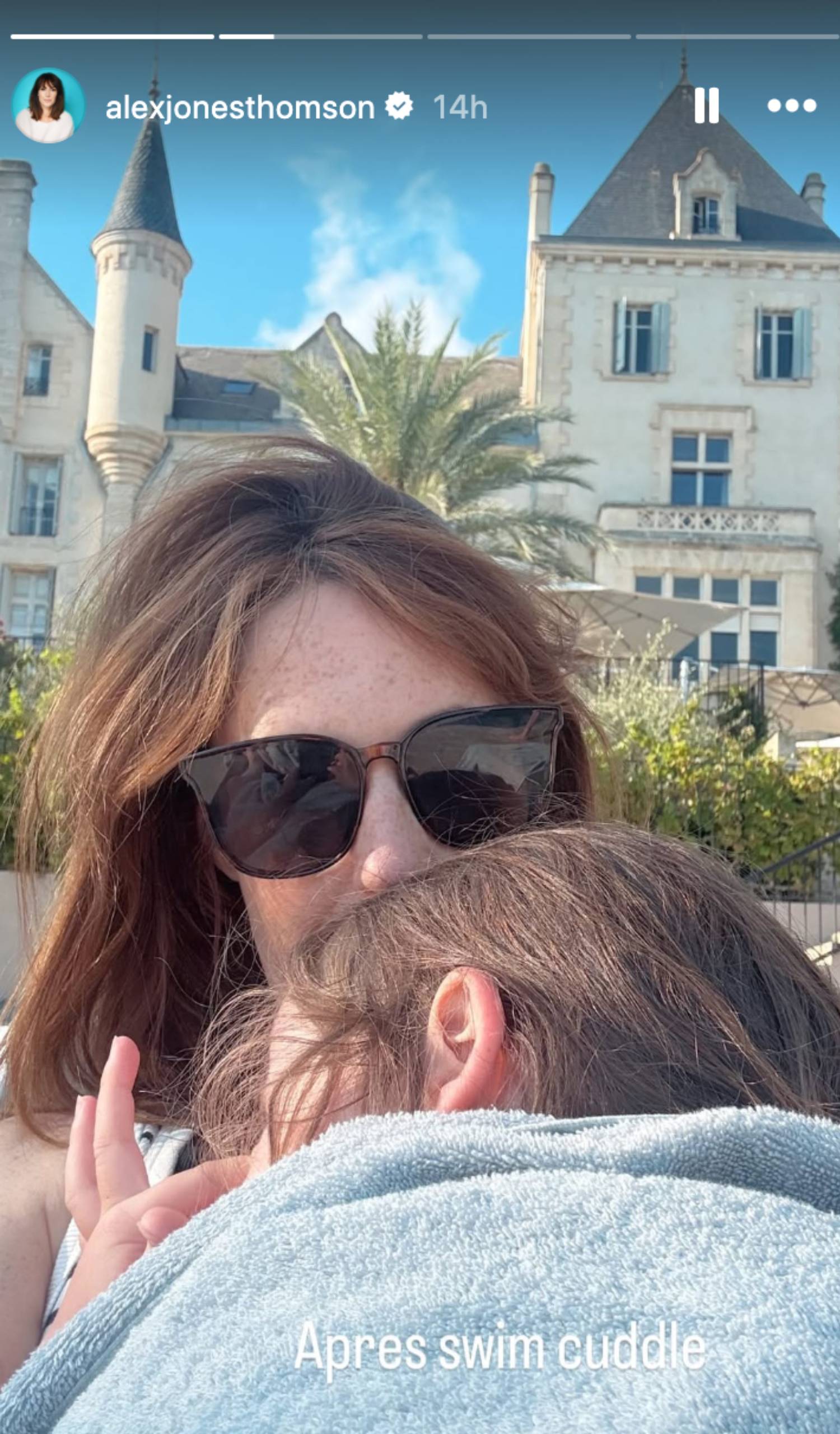 Alex Jones cuddles her child