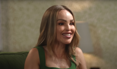 Katie Piper smiling in a green dress