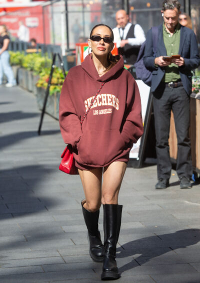 Myleene Klass walking outside in sunglasses