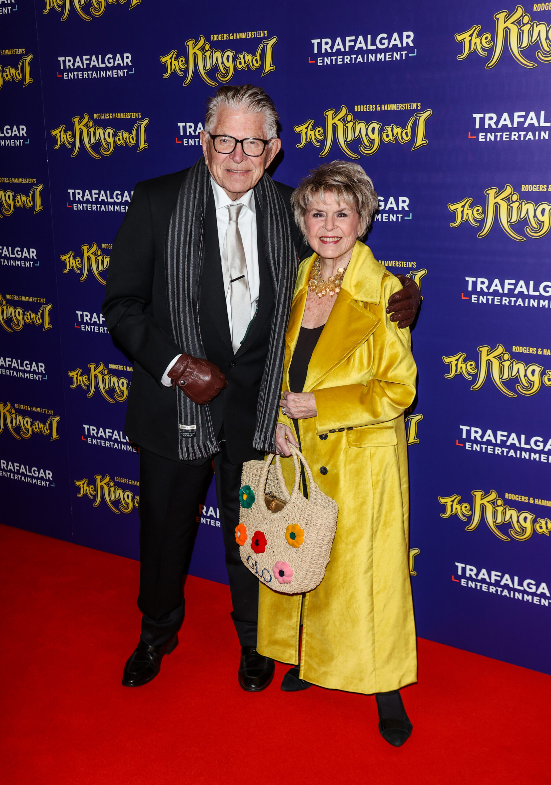 Gloria and her husband on a red carpet