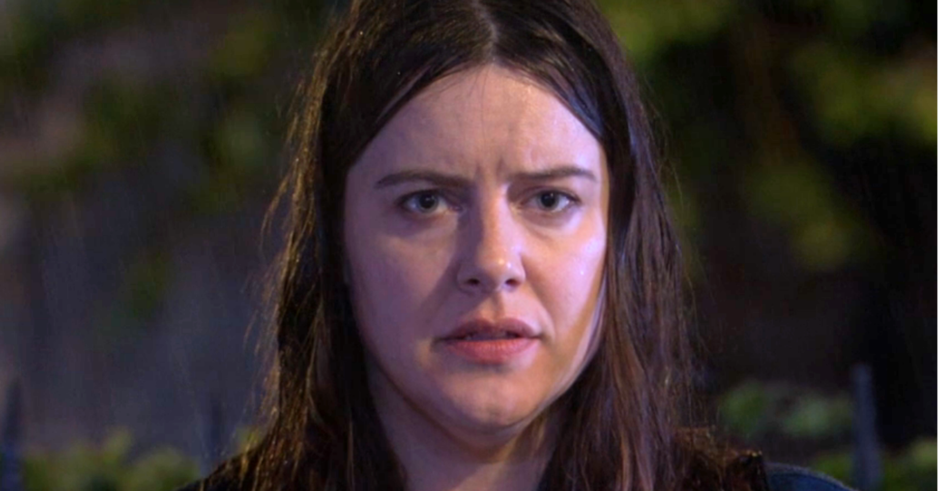 Zoe looking solemn in the rain on EastEnders (Credit: BBC/Composite: ED!)