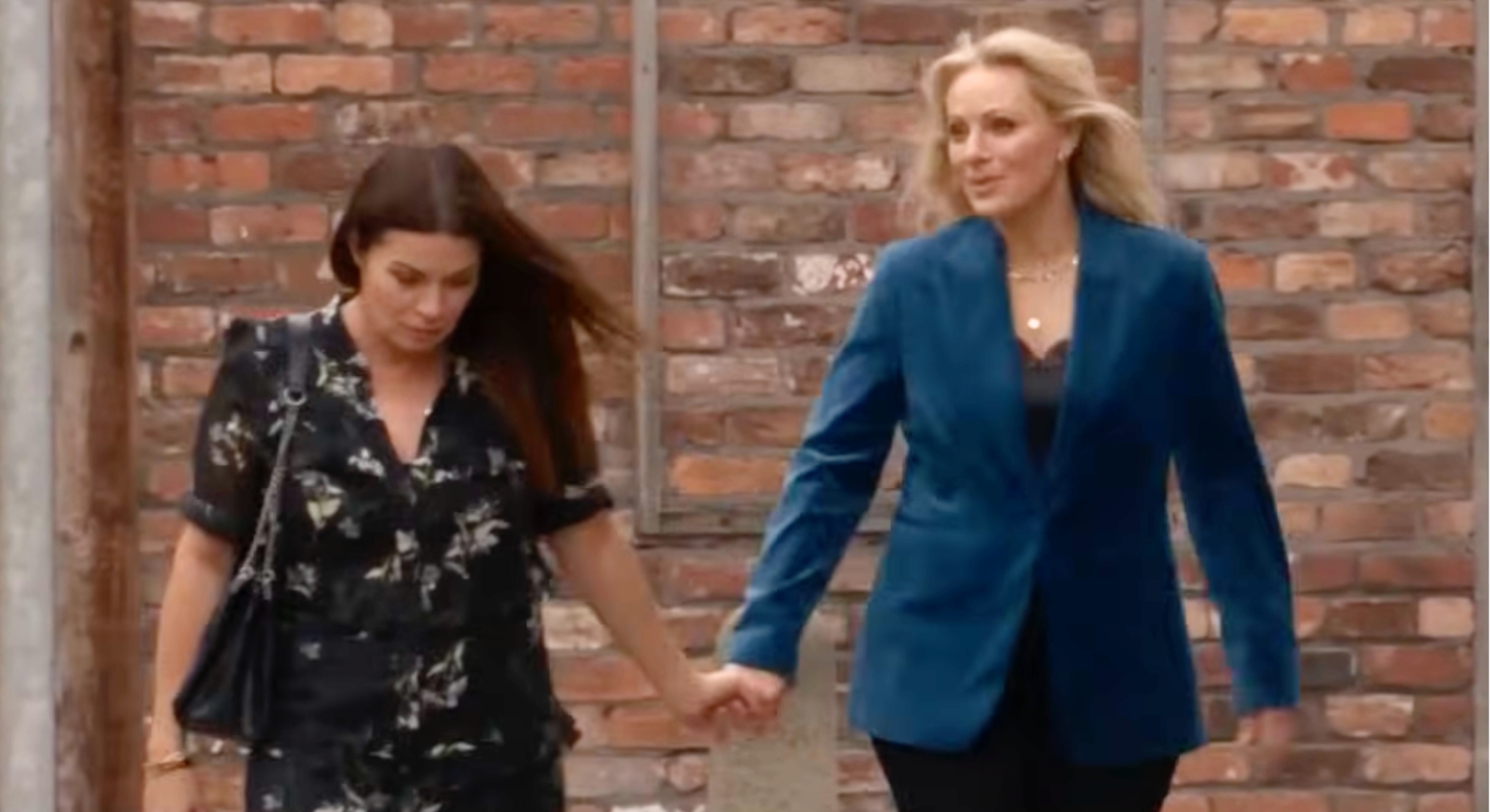 Carla and Lisa holding hands on Coronation Street