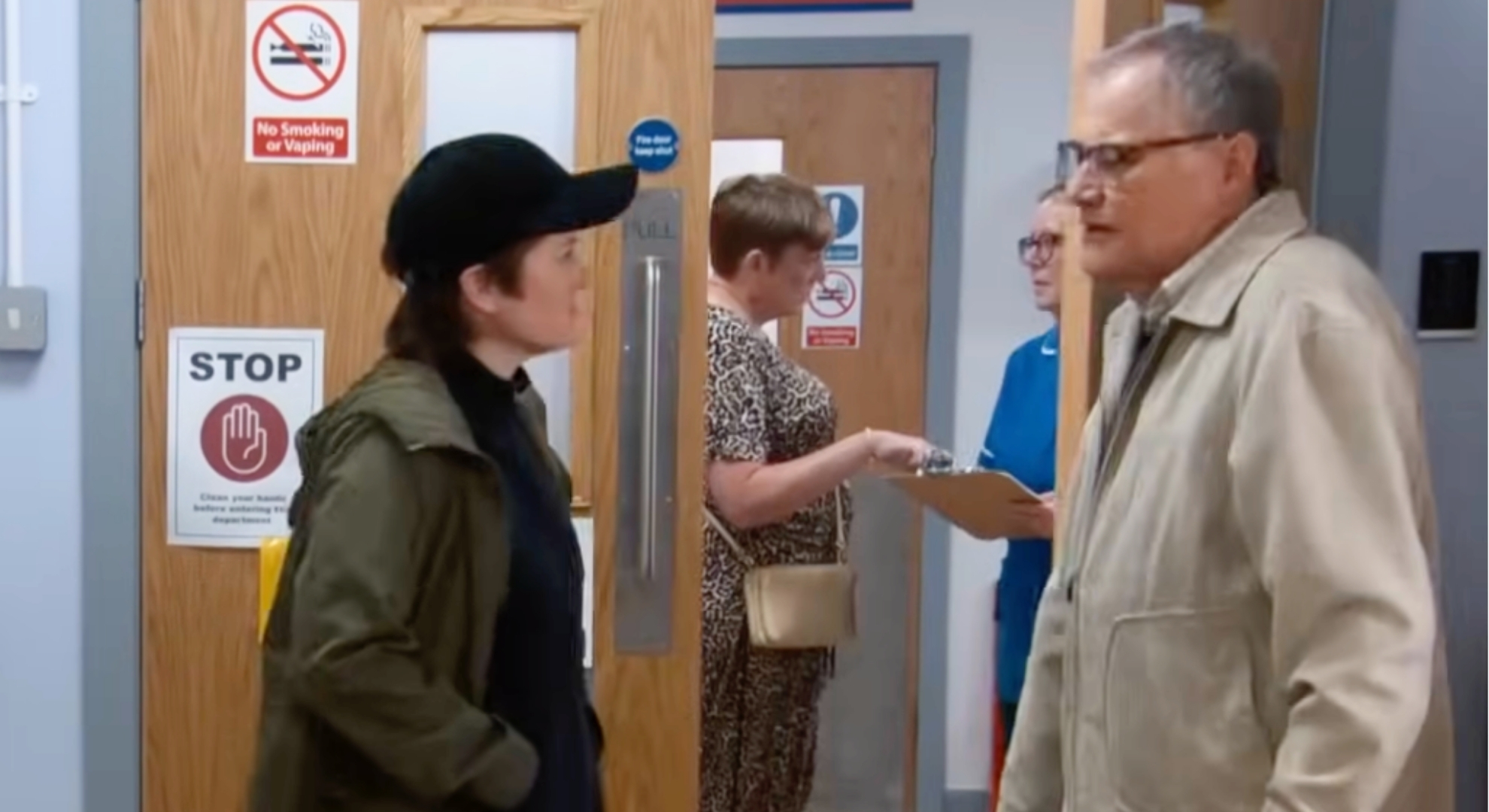 Roy talking to woman at hospital in Coronation Street