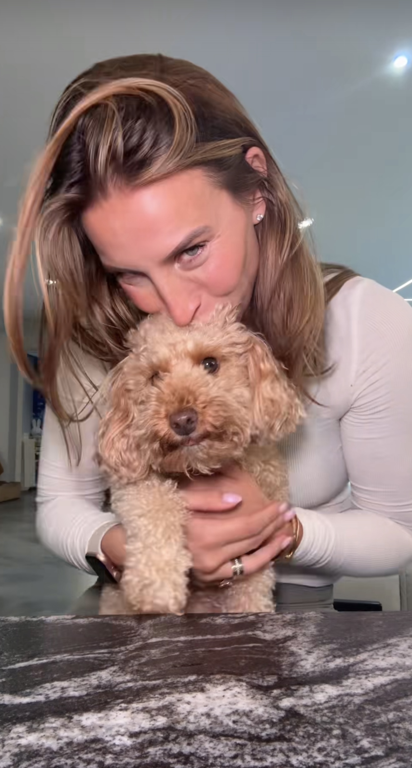 Ferne McCann giving dog Clemmie a kiss on the head in TikTok video
