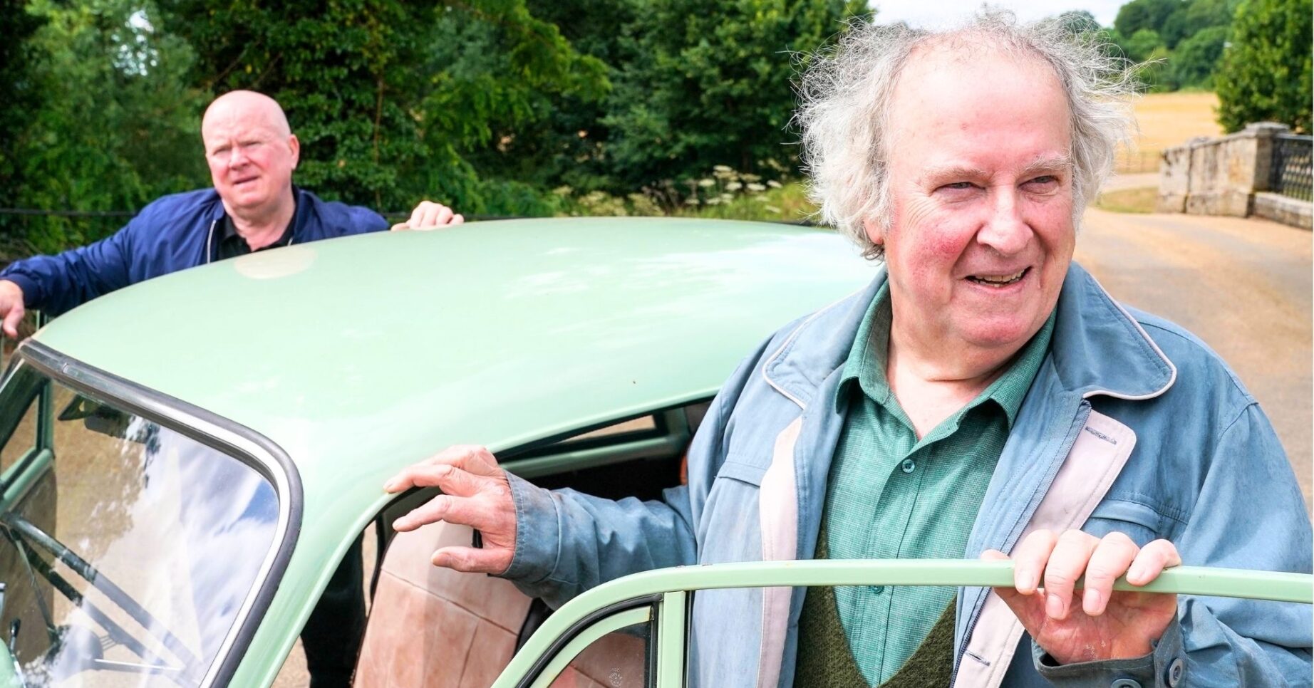 Nigel and Phil by their car in the countryside (Credit: BBC/Composite: ED)