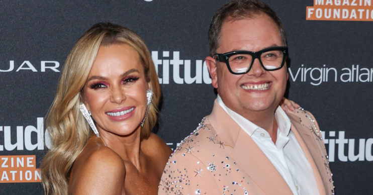 Amanda Holden and Alan Carr at a red carpet event.