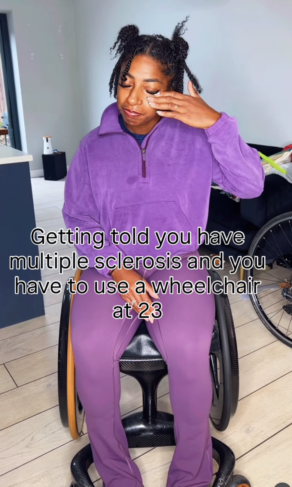 Kadeena Cox wiping away tears in a wheelchair