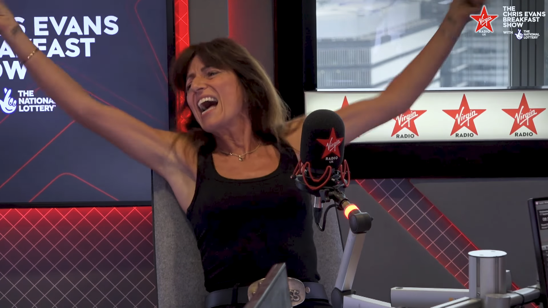 Davina McCall cheering with her arms in the air