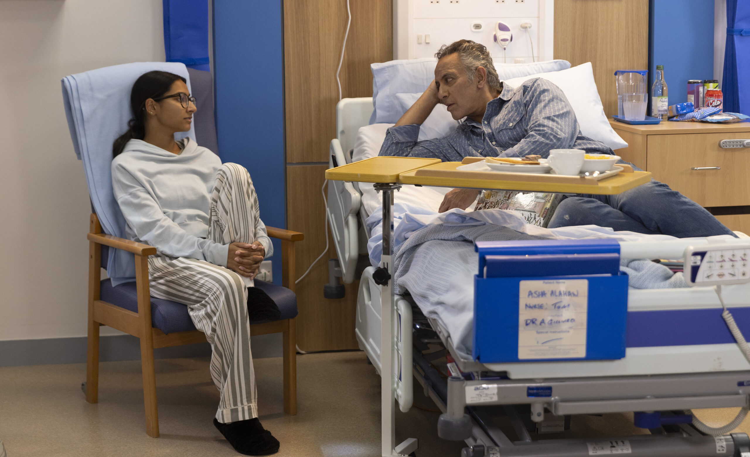 Asha and Dev talking at the hospital