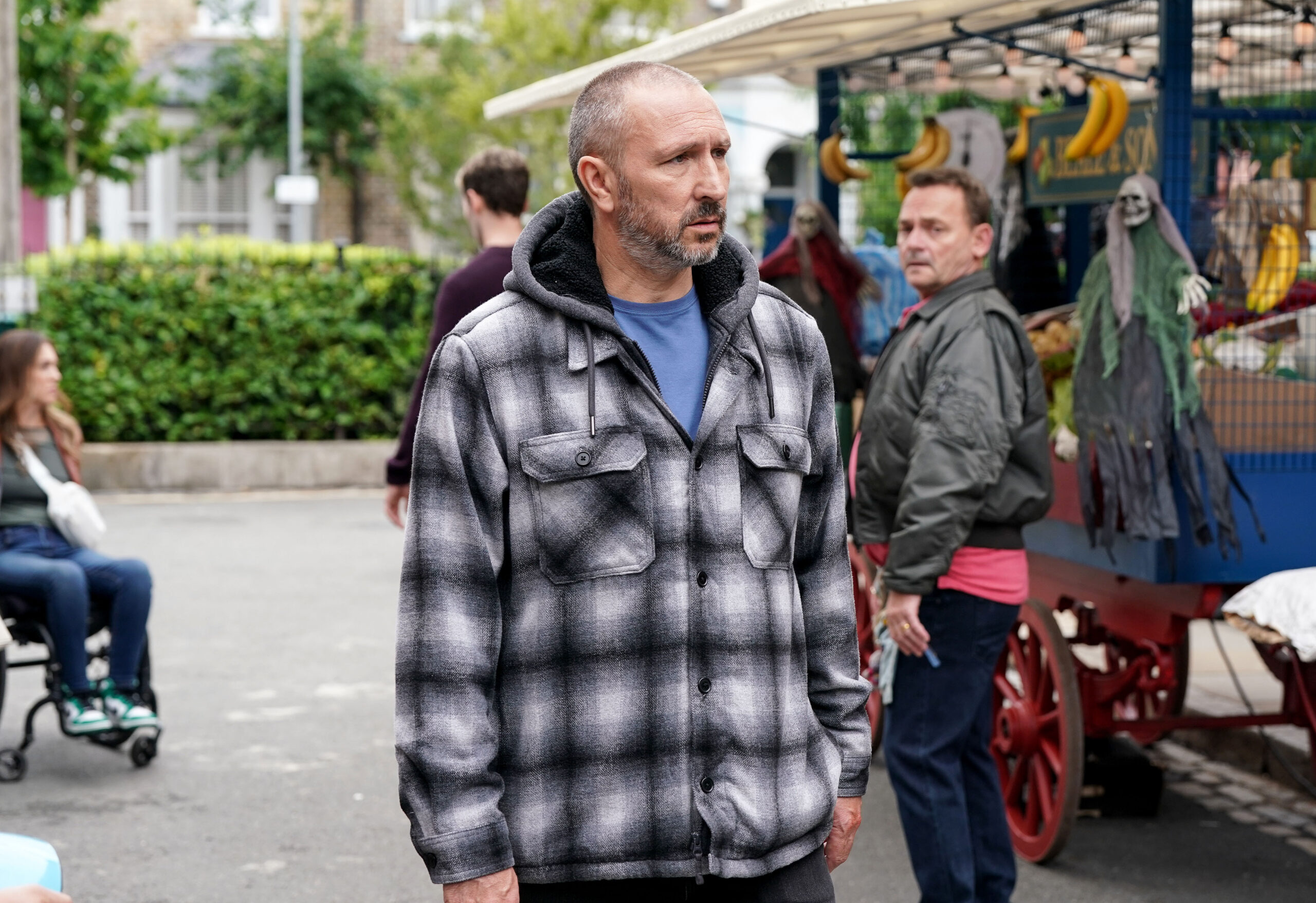 Ross looks miserable in the market on EastEnders