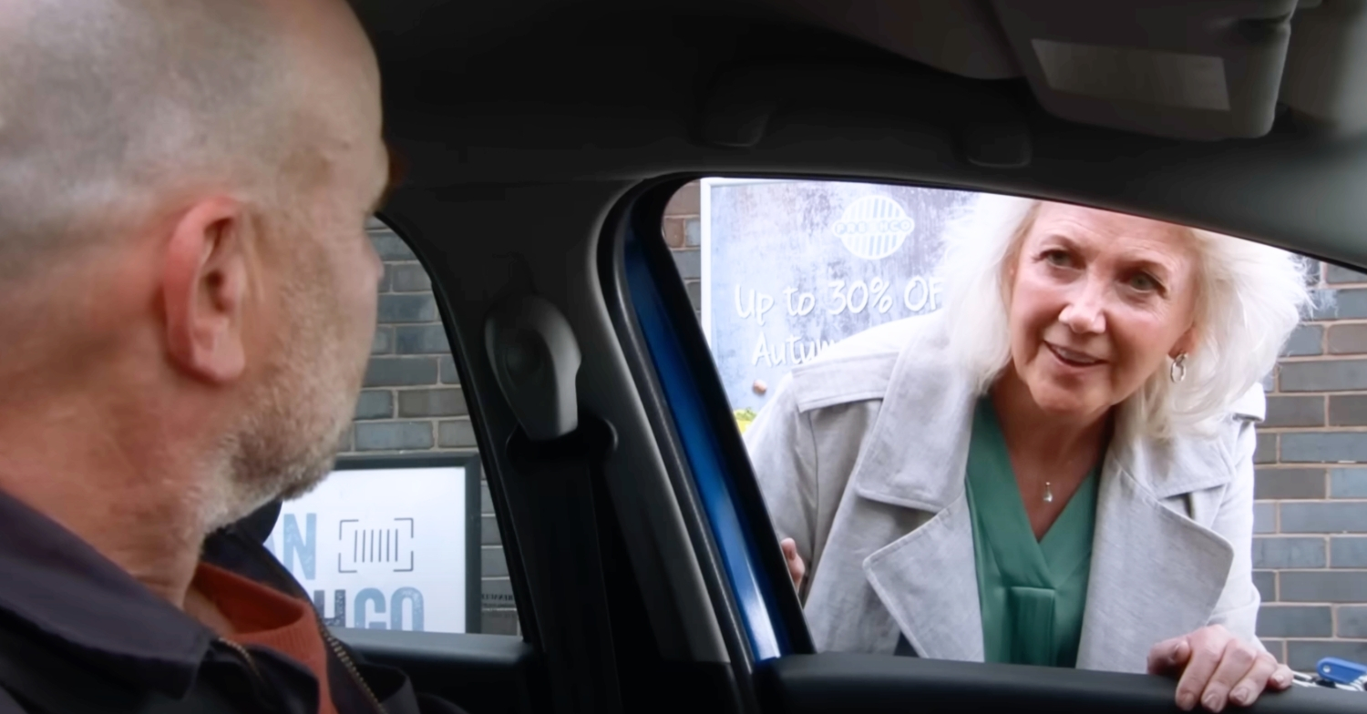 Trisha peering into Tim's car in Coronation Street