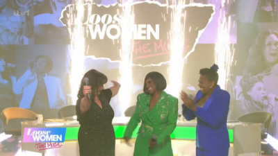 Loose Women stars singing with lights in the background