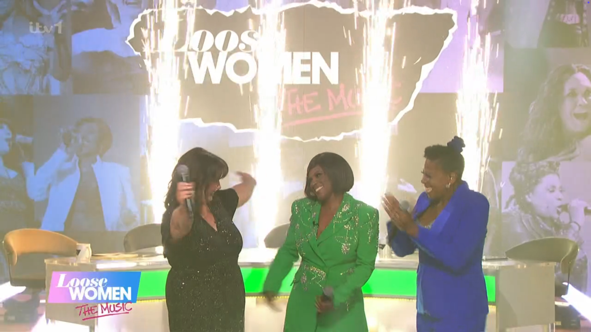 Loose Women stars singing with lights in the background