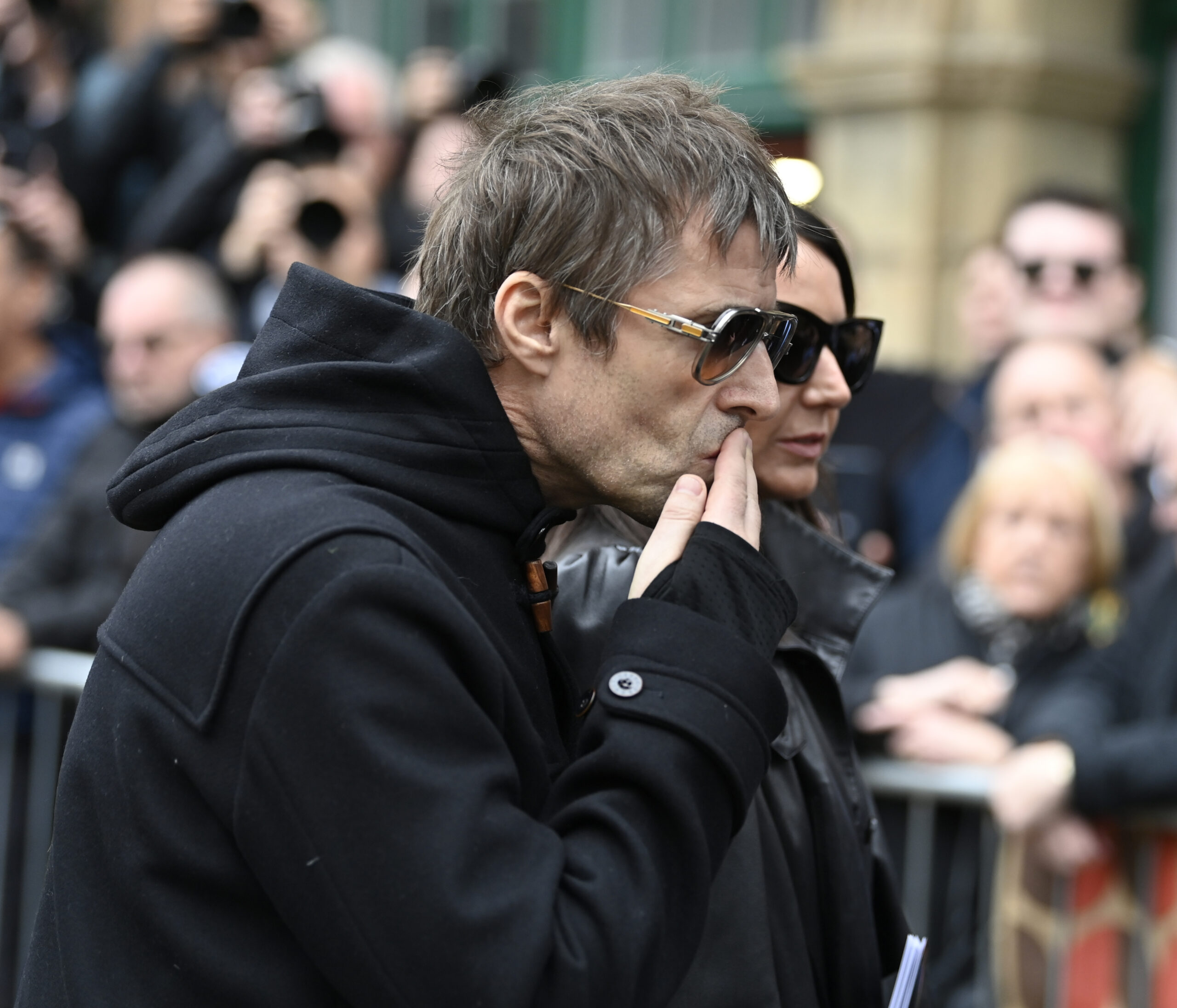 Liam Gallagher planting a kiss on the hearse 