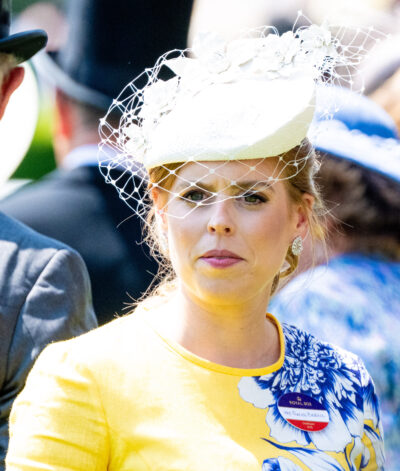 Princess Beatrice wearing a white hat and a yellow dress