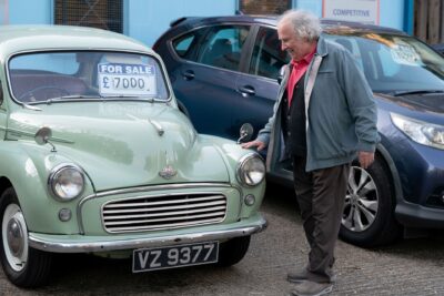 Nigel smiles as he looks at his car
